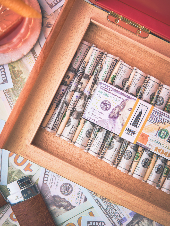 A wooden box packed with $100 bills